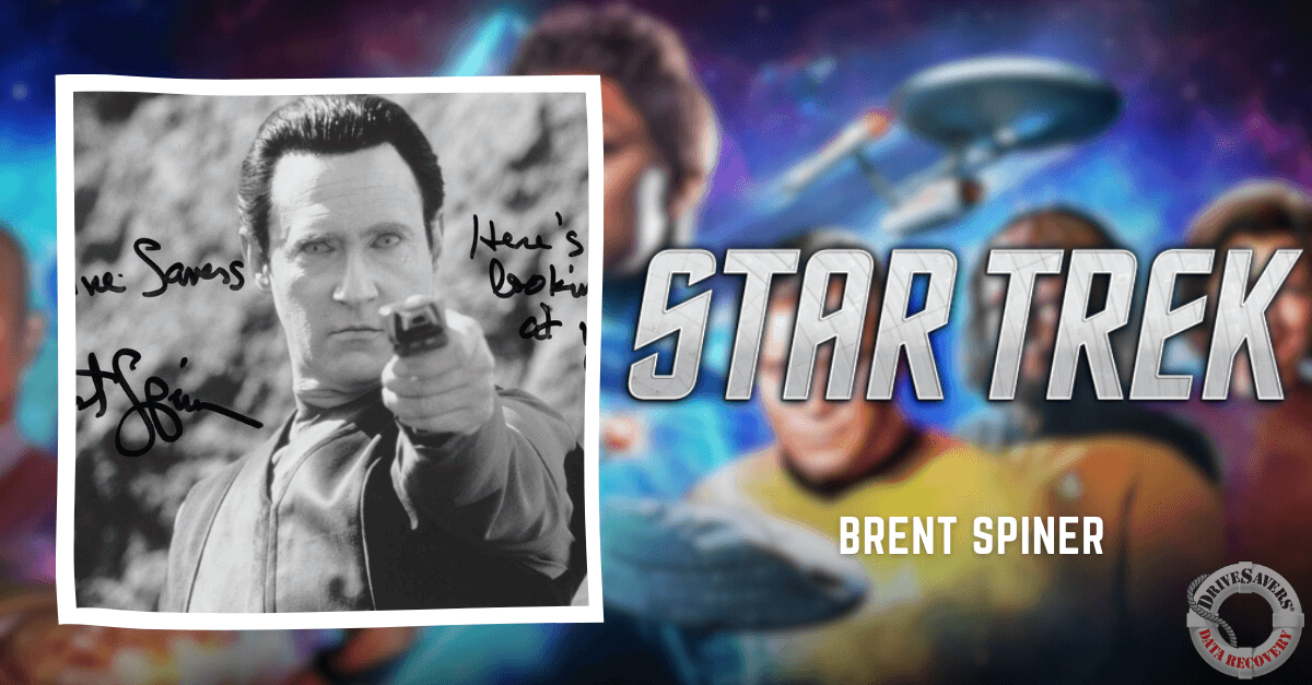 It sounds like you have a collectible or a piece of fan art! This image features Brent Spiner, who is best known for playing the character Data in Star Trek: The Next Generation. He's depicted pointing a phaser, with recognizable Star Trek themes and possibly other characters or elements from the franchise in the background. If you're a fan of Star Trek, this signed photo is likely to be a cherished item. Make sure to store it properly to preserve its condition, especially since it's signed which can add significant value for collectors and fans alike.